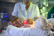 © ADDICTIVE STOCK - Nurse gently touching fragile newborn in neonatal incubator
