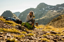 Female Hiker With Water Resting In Mountains