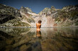 © ADDICTIVE STOCK - Woman taking bath in mountain lake