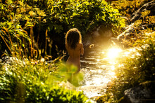 Woman Taking Bath In Mountain River