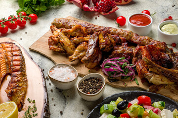 Poster - platter of different kebabs, pork,beef,chicken,lamb,veal,salmon, lula kebab on stone table