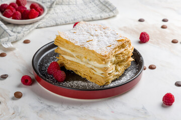 Napoleon dessert on plate on white marble table