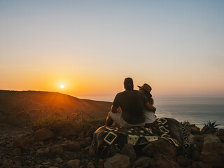 Wall Mural - Couple watching the sunset, Baja California, Mexico