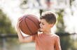 © Louis-Photo - portrait of a boy kid playing with a basketball in park