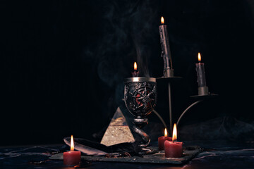 Wall Mural - Witchcraft composition with burning candles, jewelry and pentagram symbol. Halloween and occult concept, black magic ritual.