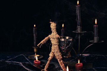 Sticker - Voodoo Magic concept. Voodoo doll studded with needles with pierced rag heart on pentagram and around burning candles. Spooky or eerie magical esoteric ritual.