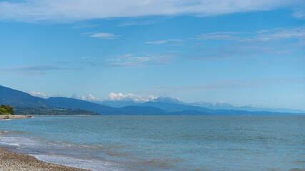 Horizon on a calm blue sea with blue mountains