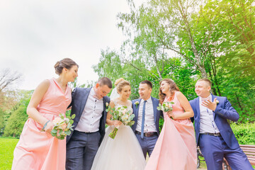 Wall Mural - Funny wedding moment of newlyweds and bridesmaids and groomsmen.