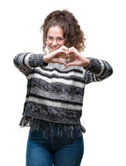 Sticker - Beautiful brunette curly hair young girl wearing glasses over isolated background smiling in love showing heart symbol and shape with hands. Romantic concept.