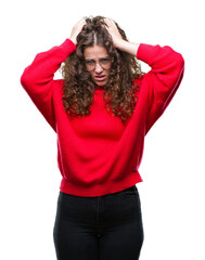 Sticker - Beautiful brunette curly hair young girl wearing glasses and winter sweater over isolated background suffering from headache desperate and stressed because pain and migraine. Hands on head.