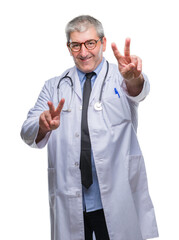 Canvas Print - Handsome senior doctor man over isolated background smiling looking to the camera showing fingers doing victory sign. Number two.