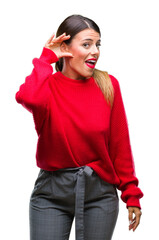 Poster - Young beautiful business woman wearing winter sweater over isolated background smiling with hand over ear listening an hearing to rumor or gossip. Deafness concept.