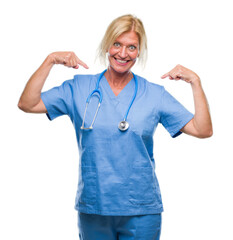 Sticker - Middle age blonde nurse surgeon doctor woman over isolated background looking confident with smile on face, pointing oneself with fingers proud and happy.