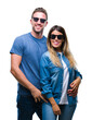 © Krakenimages.com - Young couple in love wearing sunglasses over isolated background with a happy and cool smile on face. Lucky person.