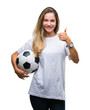 © Krakenimages.com - Young beautiful blonde woman holding soccer ball over isolated background happy with big smile doing ok sign, thumb up with fingers, excellent sign