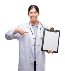 Sticker - Young hispanic doctor woman holding clipboard with surprise face pointing finger to himself