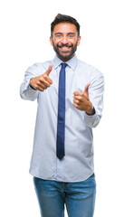 Adult hispanic business man over isolated background approving doing positive gesture with hand, thumbs up smiling and happy for success. Looking at the camera, winner gesture.