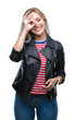 © Krakenimages.com - Young blonde woman wearing black jacket over isolated background doing ok gesture with hand smiling, eye looking through fingers with happy face.