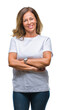 © Krakenimages.com - Middle age senior hispanic woman over isolated background happy face smiling with crossed arms looking at the camera. Positive person.