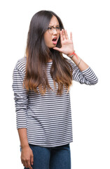 Sticker - Young asian woman wearing glasses over isolated background shouting and screaming loud to side with hand on mouth. Communication concept.