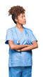 © Krakenimages.com - Young african american doctor woman over isolated background smiling looking to the side with arms crossed convinced and confident