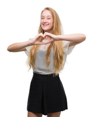 Wall Mural - Blonde teenager woman wearing moles shirt smiling in love showing heart symbol and shape with hands. Romantic concept.