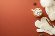 Winter concept. Top view photo of knitted bobble hat mittens cup of cocoa with marshmallow on rattan serving mat pine cone anise and cinnamon sticks on isolated brown background with empty space