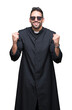 © Krakenimages.com - Young Christian priest wearing sunglasses over isolated background celebrating surprised and amazed for success with arms raised and open eyes. Winner concept.