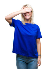 Poster - Young beautiful blonde woman wearing glasses over isolated background smiling and laughing with hand on face covering eyes for surprise. Blind concept.