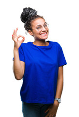 Sticker - Young braided hair african american girl wearing glasses over isolated background smiling positive doing ok sign with hand and fingers. Successful expression.