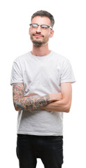 Wall Mural - Young tattooed adult man smiling looking side and staring away thinking.
