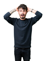 Canvas Print - Young handsome man over isolated background Crazy and scared with hands on head, afraid and surprised of shock with open mouth