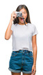 © Krakenimages.com - Young asian woman holding vintagera photo camera over isolated background scared in shock with a surprise face, afraid and excited with fear expression