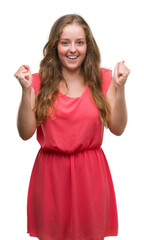 Wall Mural - Young blonde woman wearing pink dress screaming proud and celebrating victory and success very excited, cheering emotion
