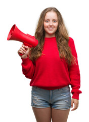 Wall Mural - Young blonde woman holding red megaphone with a happy face standing and smiling with a confident smile showing teeth