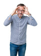 © Krakenimages.com - Handsome middle age elegant senior man wearing glasses over isolated background Trying to open eyes with fingers, sleepy and tired for morning fatigue