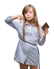 Sticker - Young blonde child holding chocolate bar with angry face, negative sign showing dislike with thumbs down, rejection concept