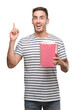 © Krakenimages.com - Handsome young man eating popcorn surprised with an idea or question pointing finger with happy face, number one