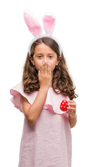 Poster - Brunette hispanic girl wearing easter rabbit ears cover mouth with hand shocked with shame for mistake, expression of fear, scared in silence, secret concept