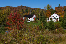 Rural Property With Old French Style Orange And White House And Barns Set Against The Laurentian Mountains In Colourful Foliage, Stoneham-et-Tewkesbury, Quebec, Canada