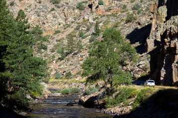 Wall Mural - Car on the scenic drive along the Cache La Poudre Wild and Scenic River in Colorado