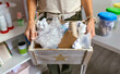 © David Pereiras - Close up of unrecognizable female teacher showing a box of waste to recycle in ecology classroom