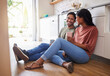 © Nina Lawrenson/peopleimages.com - Couple communication, love with coffee in the kitchen and happy together to bond in the morning. Man and woman in India on floor, smile while in conversation and romance and healthy relationship.