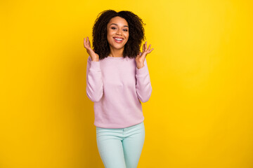 Photo of young cheerful woman show arms new hairdo wear modern outfit isolated over yellow color background