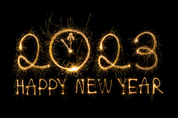 Wall Mural - Happy New Year 2023. Sparkling burning text Happy New Year 2023 isolated on black background. Beautiful Glowing golden overlay object for design holiday greeting card