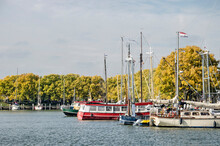 Enkhuizen,The Netherlands, October 4, 2022: Boats In The Buitenhaven (Outer Harbour) With Ash Trees In Autumn Colors In The Background