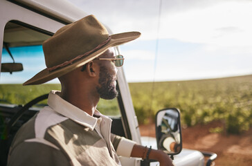 Travel, road trip and a black man by a car for a holiday motor adventure. Calm and relax person looking at countryside nature taking a break from driving and transport outdoor in the summer sun