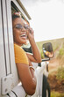 © S Fanti/peopleimages.com - Countryside, travel and road trip black woman with sunglasses and portrait for journey, transport and trendy gen z fashion. Summer, vacation and holiday drive in nature with sky mock up