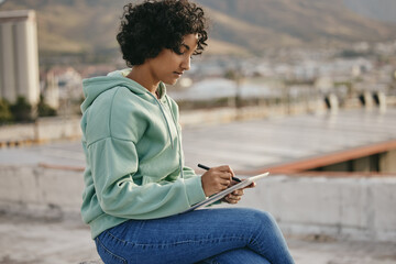 Writing, nature and tablet with a woman author, writer or poet on the search for inspiration outside. Thinking, technology and creativity with a female journalist or novelist with a story idea