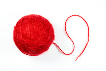 Wall Mural - A ball of red woolen threads on a white background